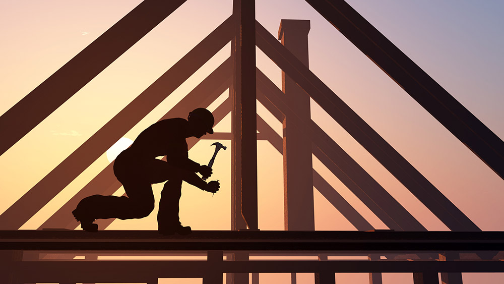 Construction worker building a house before home inspection services are scheduled 